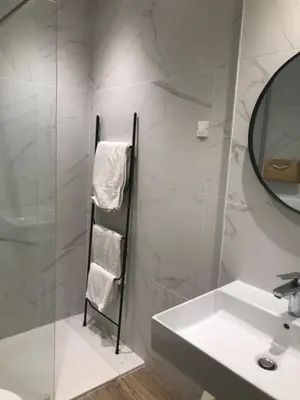 a white bathroom with a sink and a mirror at L'Acqua Viva in Calacuccia