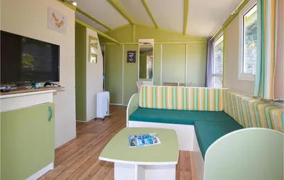 a living room with a couch and a table at Nice Stacaravan In Casalabriva in Casalabriva