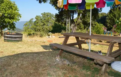 a squirrel sitting under a picnic table under an umbrella at Nice Stacaravan In Casalabriva in Casalabriva