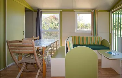 a small living room with a table and a chair at Nice Stacaravan In Casalabriva in Casalabriva