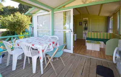 a porch with a table and chairs on a deck at Nice Stacaravan In Casalabriva in Casalabriva