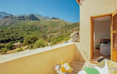a room with a balcony with a view of a mountain at Nice Home In Feliceto in Feliceto