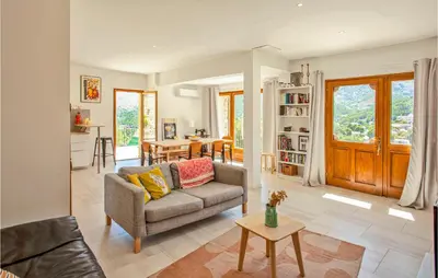 a living room with a couch and a table at Nice Home In Feliceto in Feliceto