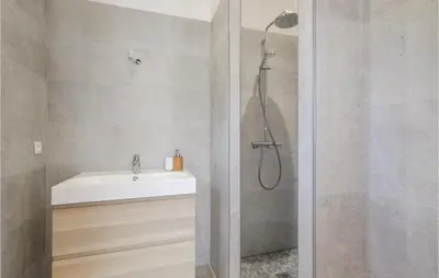 a bathroom with a shower and a white sink at Nice Home In Feliceto in Feliceto