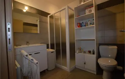 a bathroom with a toilet and a sink at Amazing Apartment In Moriani Plage in Moriani Plage