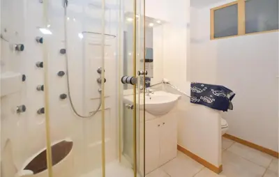 a bathroom with a shower and a sink and a toilet at Pet Friendly Apartment in Pianottoli-Caldarello