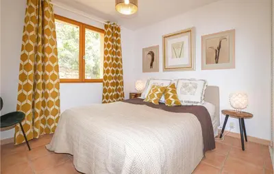 a bedroom with a bed and a window at Beautiful Home In Porto Vecchio in Porto-Vecchio