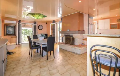 a kitchen with a table and chairs and a fireplace at Awesome Home In Borgo in Borgo
