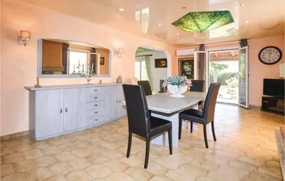 a kitchen with a table and chairs and a sink at Awesome Home In Borgo in Borgo