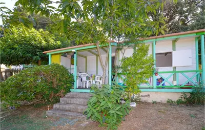 a small house with a green and white at Lovely Stacaravan In Casalabriva in Casalabriva