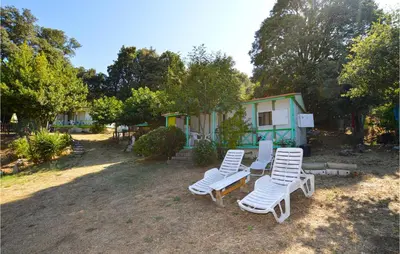 a group of lawn chairs and a house at Lovely Stacaravan In Casalabriva in Casalabriva