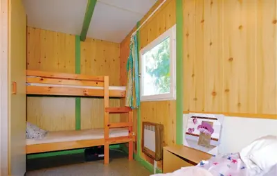 a bedroom with two bunk beds and a window at Lovely Stacaravan In Casalabriva in Casalabriva