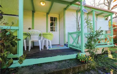 a porch of a small house with a table and chairs at Lovely Stacaravan In Casalabriva in Casalabriva