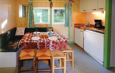 a small kitchen with a table and a couch and a table at Lovely Stacaravan In Casalabriva in Casalabriva