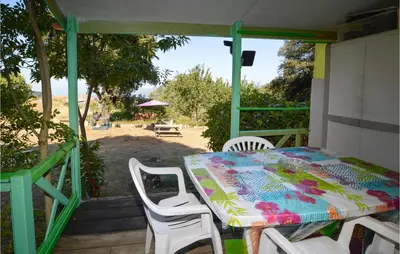 a table and chairs on the porch of a house at Lovely Stacaravan In Casalabriva in Casalabriva