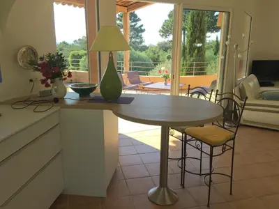 a kitchen with a table with a lamp on it at CAEDA in Porto-Vecchio