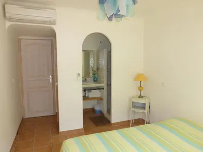 a bedroom with a bed and a mirror at CAEDA in Porto-Vecchio