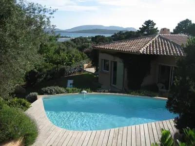 a swimming pool in front of a house at CAEDA in Porto-Vecchio