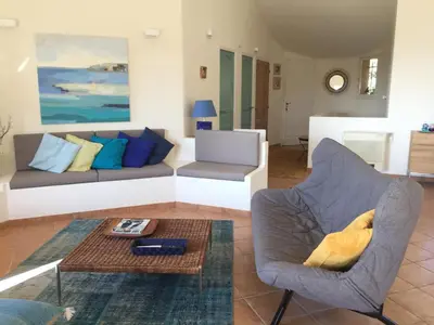 a living room with a couch and a table at CAEDA in Porto-Vecchio