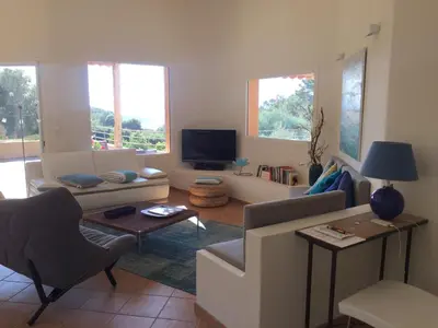 a living room with a couch and a tv at CAEDA in Porto-Vecchio