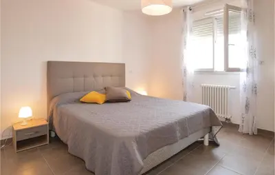 a bedroom with a bed with two pillows on it at Gorgeous Apartment In Ajaccio With Wifi in Ajaccio