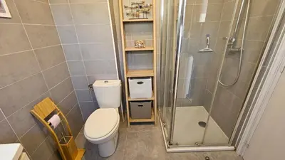 a bathroom with a toilet and a shower at Cardellini 10- vue mer-piscine en résidence in Sari Solenzara