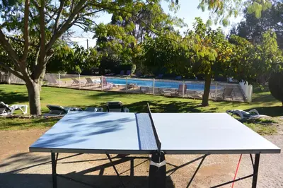 a ping pong table in front of a park at Cardellini 10- vue mer-piscine en résidence in Sari Solenzara