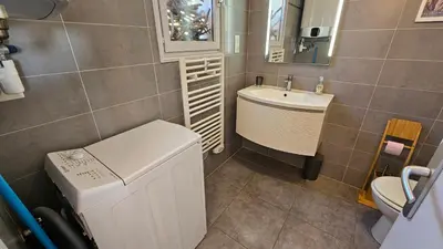 a small bathroom with a sink and a toilet at Cardellini 10- vue mer-piscine en résidence in Sari Solenzara