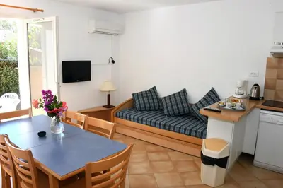 a living room with a couch and a table at Résidence Cala Bianca in Borgo