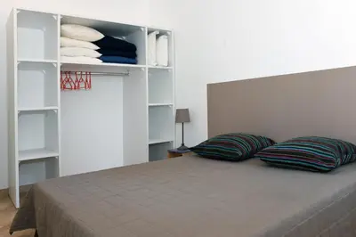 a bedroom with a bed with two pillows on it at Résidence Cala Bianca in Borgo