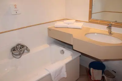 a bathroom with a sink and a bath tub at Résidence Cala Bianca in Borgo
