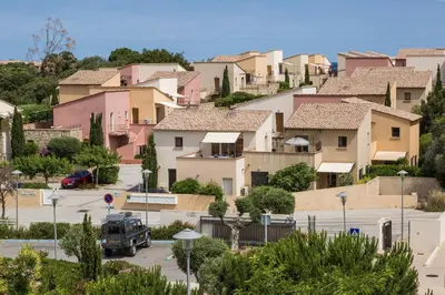 a group of houses on a hill in a city at Résidence Odalys Les Hameaux de Capra Scorsa in Belgodère