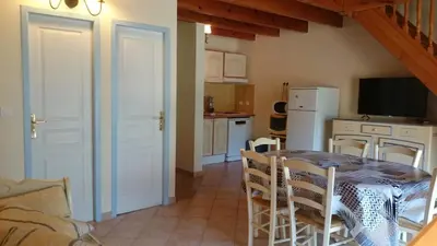 a kitchen and dining room with a table and chairs at Résidence A Barcella in Porto Ota