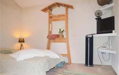a bedroom with a bed and a wooden ladder at Amazing Home In Coti-Chiavari in Coti-Chiavari
