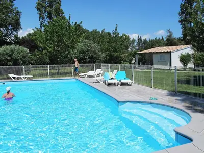 a man is standing in a swimming pool at Holiday Home A Suara-2 by Interhome in Ghisonaccia