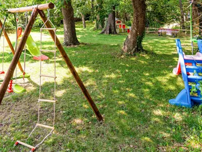 a group of playground equipment in a park at Holiday Home A Suara-2 by Interhome in Ghisonaccia