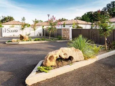 a parking lot with a street with a house at Holiday Home A Suara-2 by Interhome in Ghisonaccia