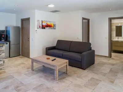 a living room with a couch and a coffee table at Holiday Home A Suara-2 by Interhome in Ghisonaccia