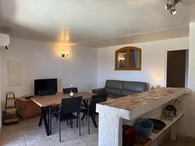 a living room with a table and a couch at CAROLE F3 in Sainte-Lucie de Porto-Vecchio