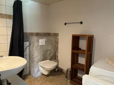 a bathroom with a toilet and a sink at CAROLE F3 in Sainte-Lucie de Porto-Vecchio