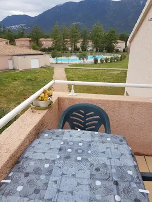 a table on a balcony with a bowl of fruit at Domaine de Mélody in Moriani Plage