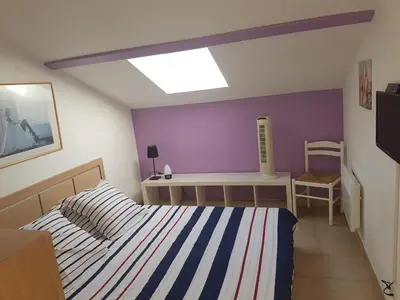 a bedroom with a bed and a table and a desk at Domaine de Mélody in Moriani Plage