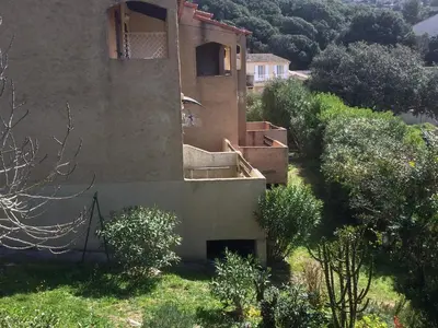 an external view of a house with bushes and trees at Suarella in Propriano