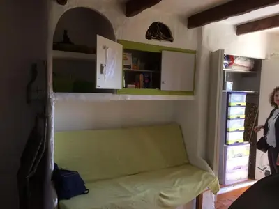 a room with a green couch in a room at Suarella in Propriano