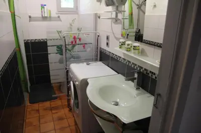 a small bathroom with a sink and a mirror at Suarella in Propriano