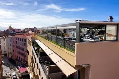 a building with a balcony with a view of a city at Hôtel Fesch & Spa in Ajaccio