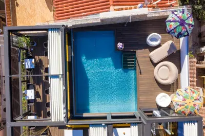 a swimming pool on the side of a building at Hôtel Fesch & Spa in Ajaccio