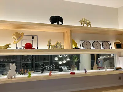 a shelf with clocks and other items on it at Golden Tulip Porto-Vecchio in Porto-Vecchio