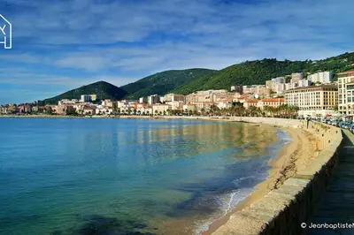 a view of a beach with buildings and the water at Carlota - Appartement rénové au cœur de la vieille ville - by TGB in Ajaccio