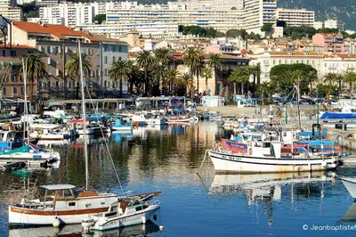 a group of boats are docked in a harbor at Carlota - Appartement rénové au cœur de la vieille ville - by TGB in Ajaccio